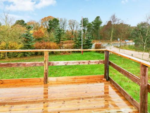 a wooden deck with a view of a field at 6 person holiday home in Hadsund-By Traum in Hadsund