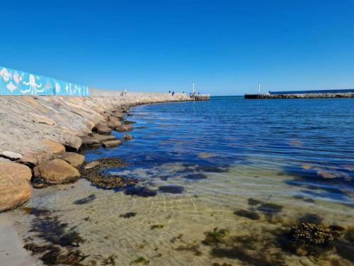 a beach with a pier and the water at 6 person holiday home in Hadsund-By Traum in Hadsund