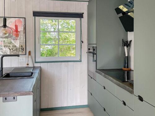 a kitchen with a sink and a window at Tranquil Oasis with Pool - By Traum Ferienwohnungen in Ørsted