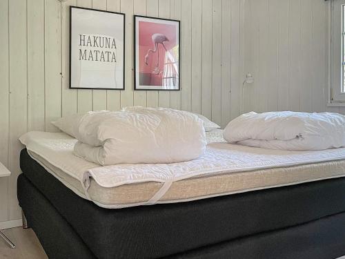 a bed with two pillows on top of it at Tranquil Oasis with Pool - By Traum Ferienwohnungen in Ørsted