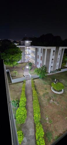 a view of a building at night with a garden at The Central Comfort in Kingston