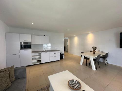 a large living room with a table and a kitchen at Pelikaan apartment - Regal Rentals Curacao in Grote Berg