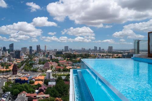 a view of the city from a swimming pool at Bassac Signature Hotel & Residence in Phnom Penh