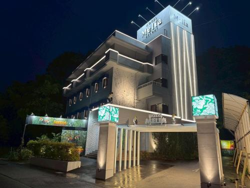 a hotel building with a sign on it at night at Hotel Melia RESORT(Adult Only) in Fuefuki