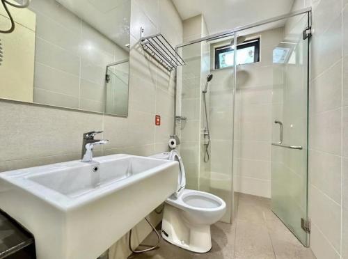 a bathroom with a sink and a toilet at Atlantis Residences Melaka in Melaka