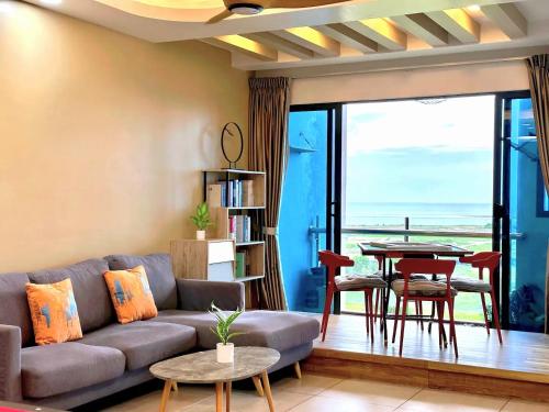 a living room with a couch and a table at Atlantis Residences Melaka in Melaka