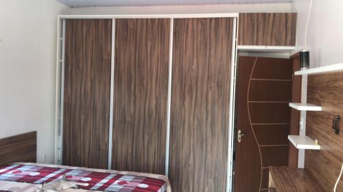 a bedroom with a wooden closet and a bed at Cantinho da Gente in Belém