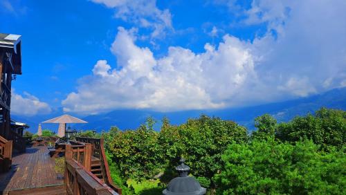 a wooden deck with a view of the mountains at Yosemite Park B&B in Renai