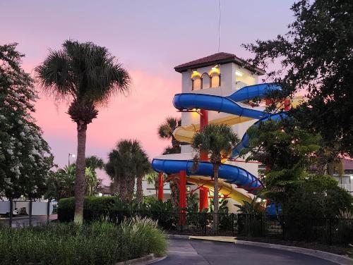 a water slide in front of a building at Family Townhouse with Waterpark - Minutes from Disney in Kissimmee