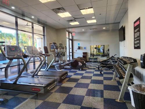 a gym with treadmills and cardio equipment in a room at Family Townhouse with Waterpark - Minutes from Disney in Kissimmee