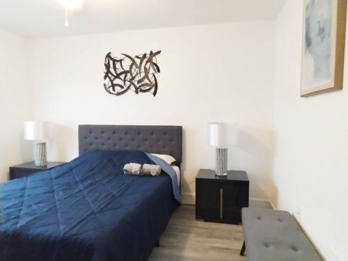 a bedroom with a blue bed and two night stands at Family Townhouse with Waterpark - Minutes from Disney in Kissimmee