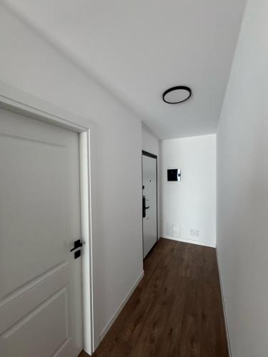 an empty room with white walls and a door at Alpha Panorama in Sarandë