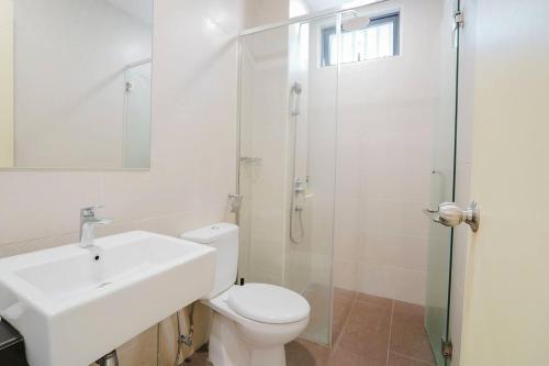 a bathroom with a toilet and a sink and a shower at Atlantis Residences Melaka in Melaka