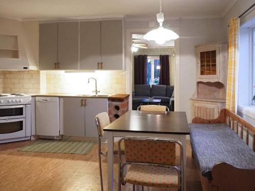 a kitchen and living room with a table and chairs at 4 person holiday home in LUR-By Traum in Lur