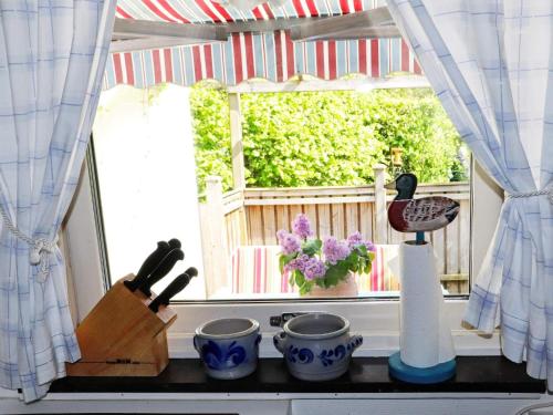a kitchen counter with a window with a cutting board at 3 person holiday home in HÖLLVIKEN-By Traum in Höllviken