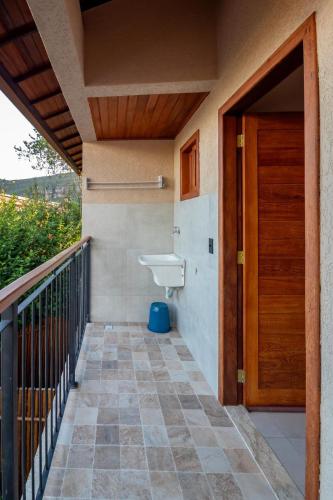 a bathroom with a toilet and a wooden door at Vila Diamantina in Mucugê