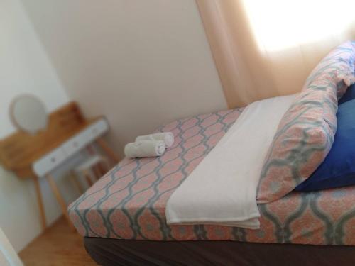 a bedroom with a bed with a tattoo on it at Avida 3-Bedroom Vacation House with Pool in Minuluang