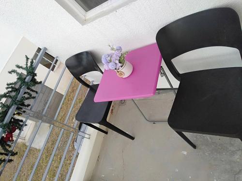 a pink table and two chairs with flowers on it at Avida 3-Bedroom Vacation House with Pool in Minuluang