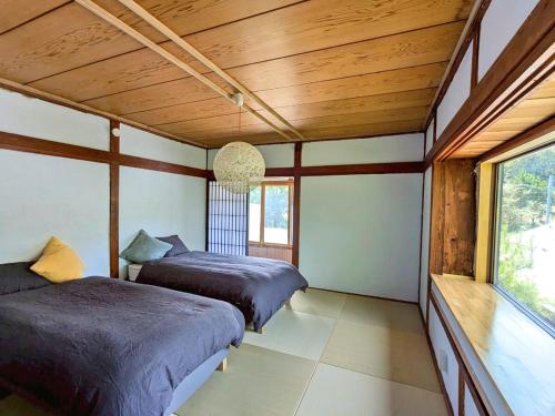 Ένα ή περισσότερα κρεβάτια σε δωμάτιο στο Kumo Lodge