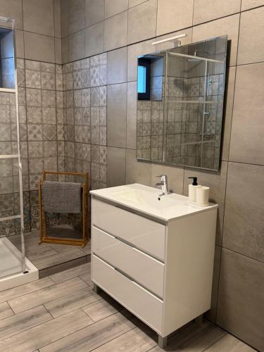 a bathroom with a white sink and a mirror at Casa Colorida in Reguengos de Monsaraz