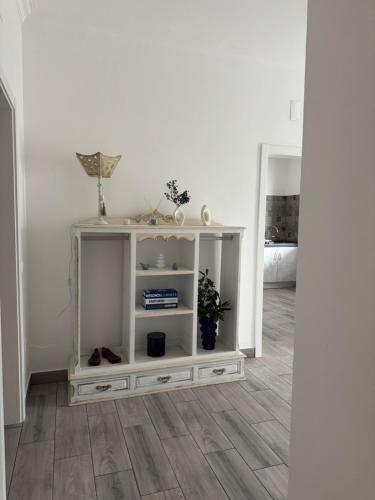 a white cabinet in a room with a floor at Casa Colorida in Reguengos de Monsaraz