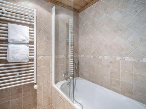 a bathroom with a shower and a bath tub at Chalet indépendant avec sauna et parking à Courchevel 1650 - 8 pers - FR-1-563-162 in Courchevel