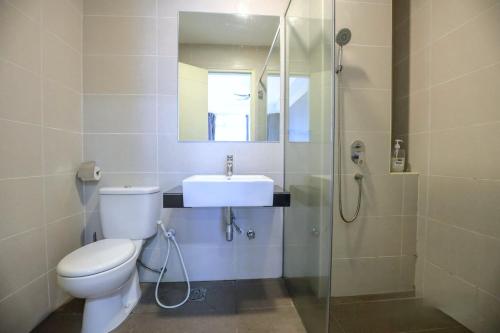 a bathroom with a toilet and a sink and a shower at Atlantis Residences Melaka in Melaka