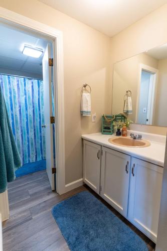 a bathroom with a sink and a mirror at Charming Waterfront Cabin - Sleeps 10 in Rocky Mount