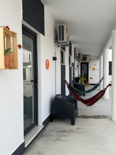 a room with a hammock and a room with a boat at Casa Colorida in Reguengos de Monsaraz
