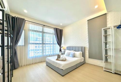a bedroom with a bed and a large window at Atlantis Residences Melaka in Melaka