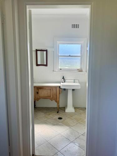 a bathroom with a sink and a window at Beltane Cottage in Canyon Leigh