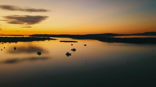 a view of a body of water at sunset at Anchors Away in Coffin Bay
