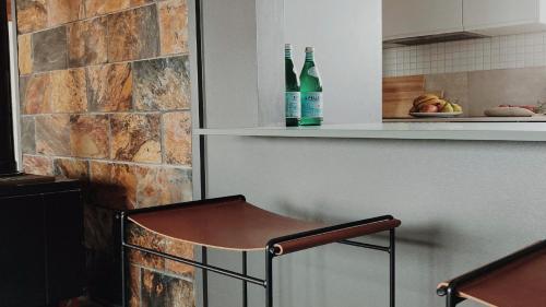 a kitchen with two bottles of wine on a shelf at Dusk Coffin Bay in Coffin Bay