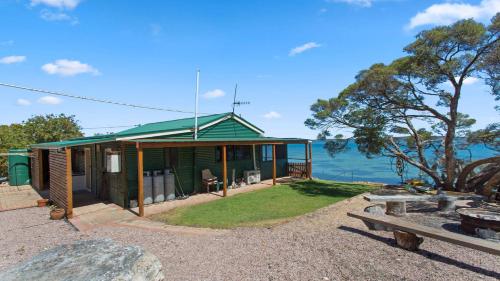 a green house with a view of the ocean at Kellidie Bliss Is Coffin Bay's Touch Of Paradise - Perfect Couples Retreat in Coffin Bay