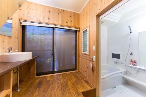a bathroom with a sink and a toilet and a tub at Nagomi Ryokan Yu - Vacation STAY 81037v in Kyoto
