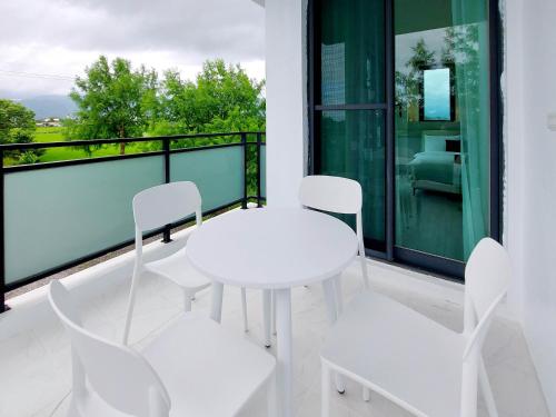 a white table and chairs on a balcony at 慢慢三星民宿 ChillaxSanxing B&B in Sanxing