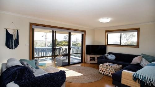 a living room with two couches and a balcony at Bay Life - Relax, Unwind andeexperience Coffin Bay Life At Its Best! in Coffin Bay