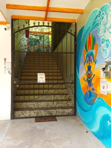 a door with a painting on the side of a building at Domi cabin large in Dominical