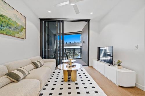 a living room with a couch and a table at 2BR Apt Lv 23 Queens Wharf Residence with Carpark - Privately Managed in Brisbane