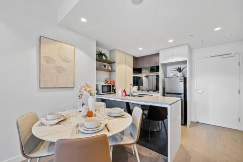 a kitchen and dining room with a table and chairs at 2BR Apt Lv 23 Queens Wharf Residence with Carpark - Privately Managed in Brisbane