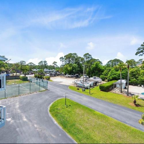 a road leading to a marina with boats parked at Bayview Condo, Boat Slip & Launch, Pool & Arcade! The Wild Wahoo! in Orange Beach