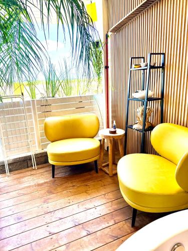 a room with two yellow chairs and a table at LOMA in Hagoshrim