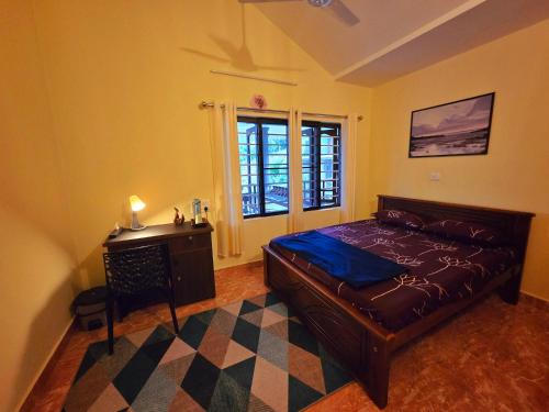 a bedroom with a large bed and a window at Tranquil Nest Villa - 4BHK Villa - Entire Villa stay in Wayanad in Kalpetta