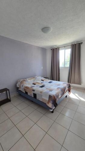a bedroom with a bed in the corner of a room at Marina Diamante Victory in Acapulco