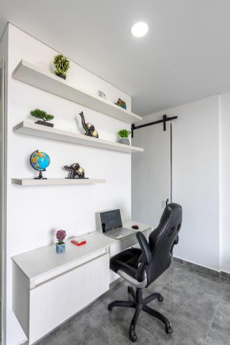 an office with a chair and a desk with a laptop at Apartahotelquimbaya in Quimbaya