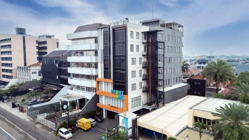 an overhead view of a tall white building at Front One Boutique Hotel Taman Anggrek in Jakarta