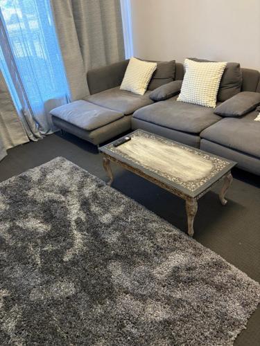 a living room with a couch and a coffee table at Freo Lodge Boutique Hostèl in Fremantle