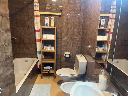 a bathroom with a toilet and a tub and a sink at Maia 3C a Pie de Pistas con garaje incluido in Pas de la Casa