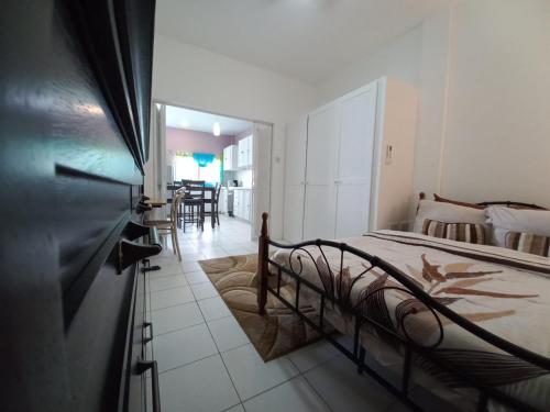 a bedroom with a bed and a dining room at Nested View in Westerhall Land Settlement
