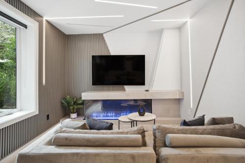 a living room with a couch and a fish tank at Designer 2BR in Downtown Steps from Sunset Beach in Vancouver